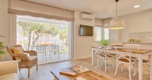 a kitchen and living room with a table and chairs at Llafranc Centre, Totally Refurbished in Llafranc +29 photos