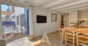 a dining room with a table and a balcony at Sant Roc Apartments a Minute From The Beach in Calella de Palafrugell