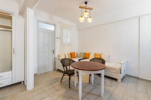 a living room with a table and a couch at Zorbas Studios in Lefkos Karpathou