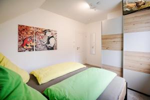 a bedroom with a bed and a painting on the wall at Der VechteSchober - Nordhorn in Nordhorn