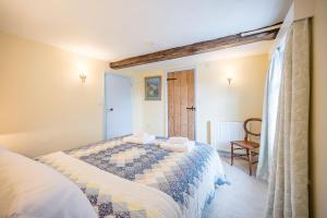 a bedroom with a bed and a chair at The Light House, Southwold in Southwold