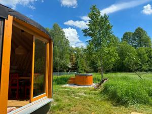 a cabin with a table in the grass at Jurajskie Jurty in Golczowice