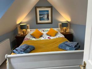 a bed with two pillows on it in a room at Planners House in Saint Monance