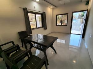 a dining room with a table and chairs at Stay Origin, In Nashik in Nashik +27 photos