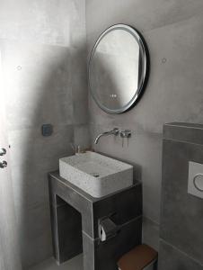 a bathroom with a sink and a mirror at Four season in Ios Chora +34 photos