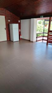 an empty room with a white refrigerator and a floor at Casa Madalina in Săpânța