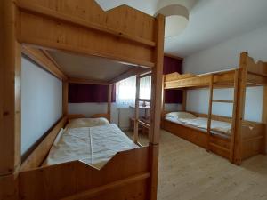 a room with two bunk beds and a table at Reiterhof Sonja in Apetlon