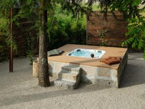 a hot tub sitting next to a tree at Villas Santo António in Baião +37 photos