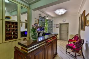 a kitchen with a bar with a pink chair at Villa Velzon Guesthouse in Budva