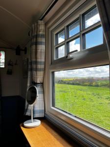 a window with a view of a green field at Shepherds Rest by the Wye in Fawley Station +8 photos