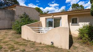 a house with a staircase leading up to a house at Lisa Maria D N38 2P5 in Sari Solenzara +3 photos