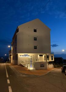 a building on the side of a street at night at O NAUTICO suites in Cabana de Bergantiños +2 photos