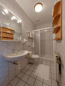 a white bathroom with a sink and a shower at Reiterhof Sonja in Apetlon +35 photos