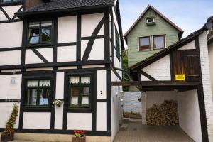 a black and white building with a garage at Fachwerkhaus Bodenwerder in Bodenwerder