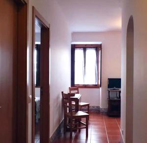 a room with a table and chairs and a window at CASA DA VILA 2, Sintra in Sintra