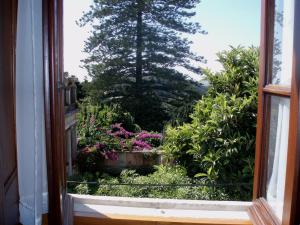 an open window with a view of a garden at CASA DA VILA 2, Sintra in Sintra