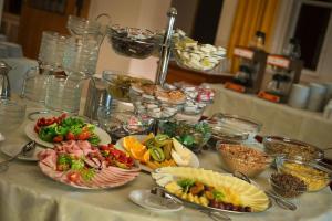 a table with many plates of food on it at EA Hotel Hrubá Skála in Hrubá Skála
