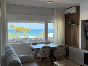 a living room with a table and a view of the ocean at Espejo del mar in Mojácar