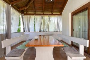 a dining room with a wooden table and benches at Apartment Modrusani 1561 in Žminj