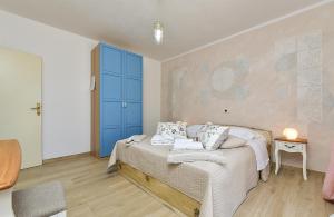 a bedroom with a bed and a blue door at Apartment Modrusani 1561 in Žminj +58 photos