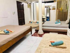 a room with two beds and a mirror at Manzanares Homestay in San Jose