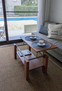 a living room with a coffee table and a couch at Gaviotas piscina comunitaria in Calafat