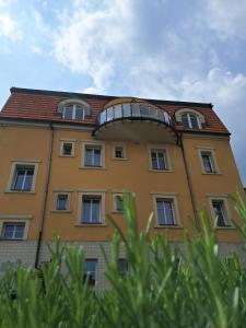 a yellow building with a balcony on top of it at Hotel Garni Rambousek in Prague