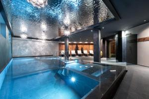 a swimming pool with a glass floor in a house at EL CIASEL in Canazei