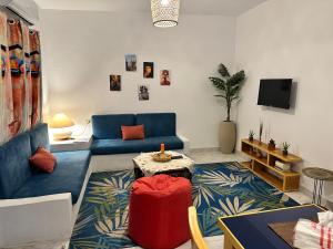a living room with a blue couch and a table at Amnesia Residence in Naama Bay - Downtown in Sharm El Sheikh