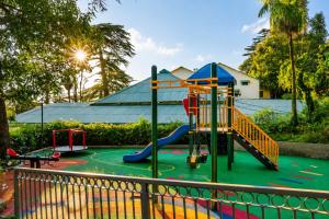 a playground with a slide in a park at Pine Retreat - A Premium Heritage Property in Mussoorie