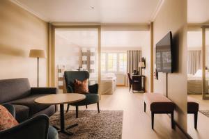 a living room with a couch and a table at Scandic Lillehammer Hotel in Lillehammer