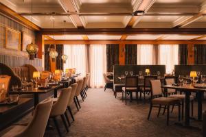 a restaurant with tables and chairs in a room at Scandic Lillehammer Hotel in Lillehammer