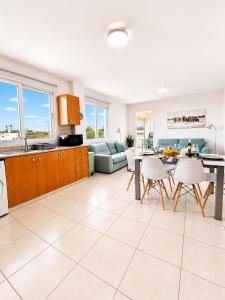 a kitchen and living room with a table and chairs at Pantelia Apartment Paralimni in Paralimni