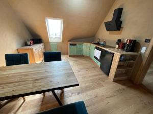 a kitchen with a wooden table in a room at Erbeskopf Gipfelquartier in Morbach