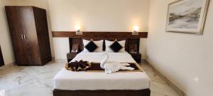 a hotel room with a bed with a swan on a tray at ANG'S Retreat By WINGS Expolores in Gangtok