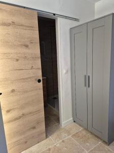 a room with a closet with a door and a mirror at Partie de ferme appartement in Paluds de Noves