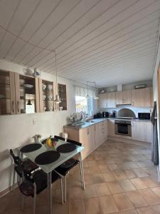 a kitchen with a table and chairs in a room at Cozy Home - Holiday, Sleepover in Rødbyhavn