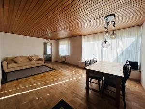 a living room with a table and a couch at Cozy Home - Holiday, Sleepover in Rødbyhavn +9 photos