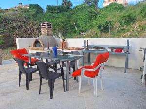 a table and chairs with a table and an oven at LASSI Apartment 2 in Argostoli