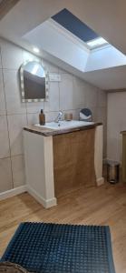 a bathroom with a sink and a mirror in a room at Les chambres de Mona in Tauriac