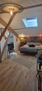 a bedroom with a bed and a skylight at Les chambres de Mona in Tauriac
