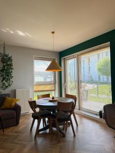 a living room with a table and chairs and a couch at Apartament Krisa z ogródkiem in Pogórze +24 photos