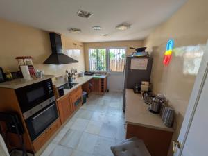 a kitchen with a sink and a stove top oven at Vincents Paradise in Mairena del Aljarafe