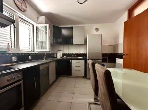 a kitchen with a sink and a refrigerator at Cozy&Spacious in Kotor