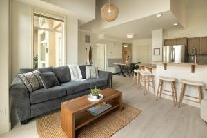 a living room with a couch and a table at sunset 101 in Kelowna