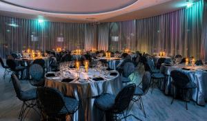 a banquet hall with tables and chairs with candles at Hard Rock Hotel Pattaya in Pattaya +110 photos