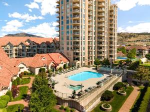 an aerial view of a large apartment building with a pool at sunset 101 in Kelowna