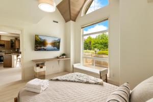 a bedroom with a bed and a large window at sunset 101 in Kelowna