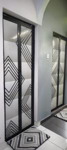 a closet with glass doors and a rug in a room at Homestay Cinta Kasih Mus'lim Only in Klang
