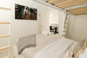 a bedroom with a white bed and a table at sunset 101 in Kelowna +58 photos